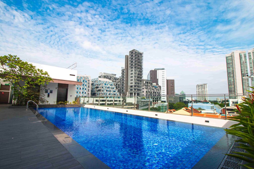 Aqueen Prestige Lavender rooftop pool with surrounding buildings