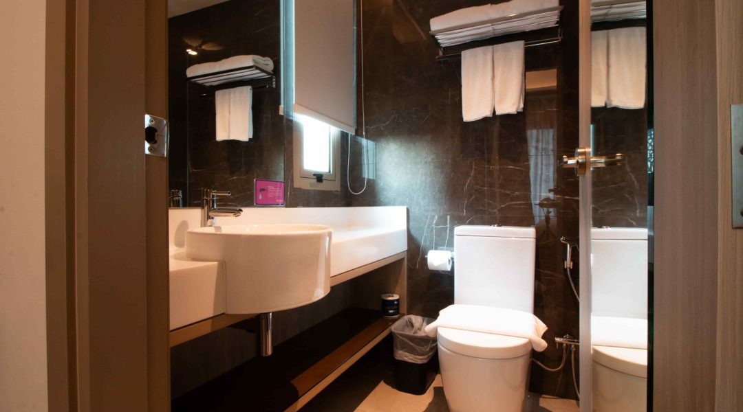 Aqueen Jalan Besar Premier Suite​ toilet with sink and toilet bowl